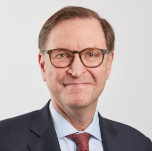 professor glenn hubbard portrait in red tie and glasses